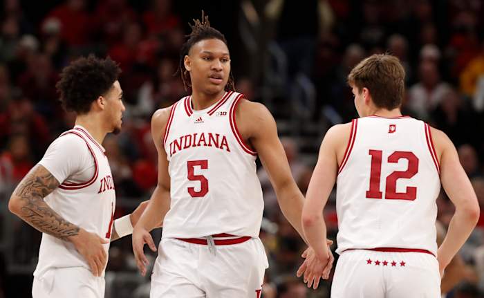 Hoosiers guard Jalen Hood-Schifino (1), forward Malik Reneau (5) and forward Miller Kopp (12) high-five during the Big Ten Men's Basketball Tournament.